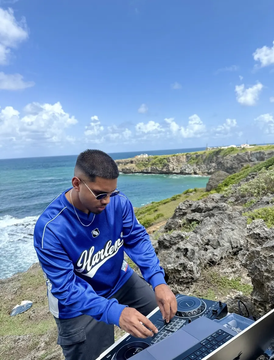DJ Shadzy mixing on a Caribbean clifftop above the ocean