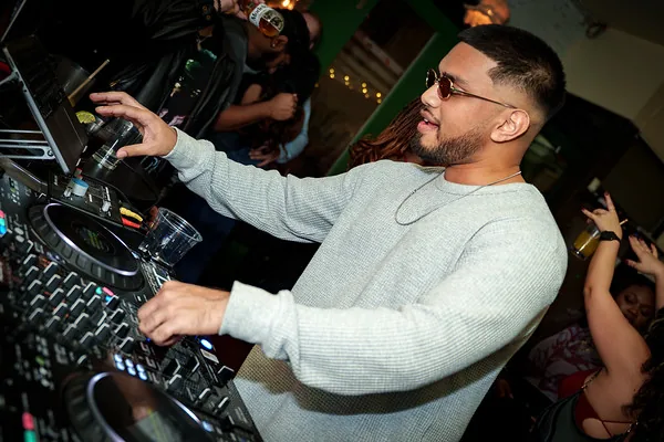 DJ Shadzy performing for a crowd at a private party